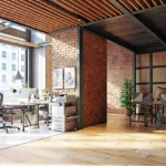 The interior of a contemporary commercial office building with hardwood floors and brick walls