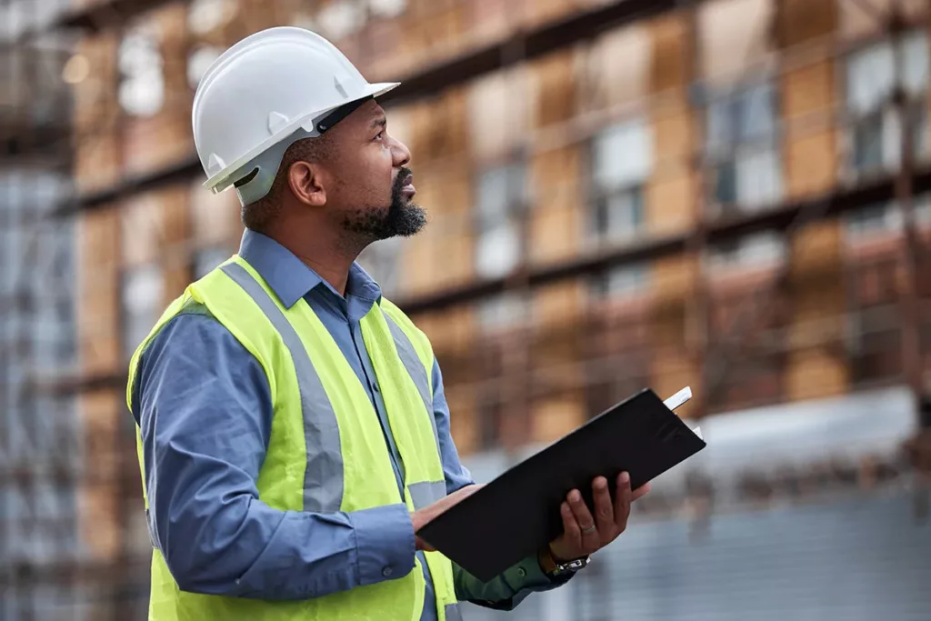 A commercial general contractor holding a clipboard