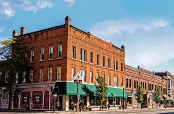 The exterior of a brick historic commercial building with lots of windows