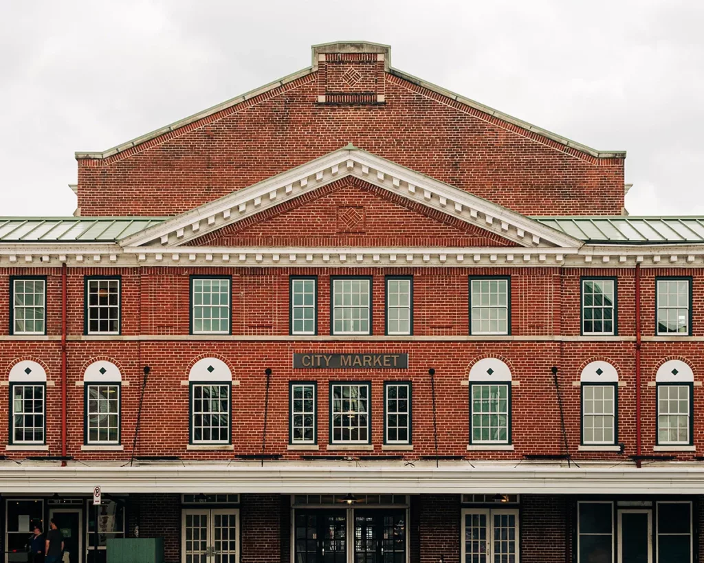 The exterior of a historic commercial building, a market with exposed brick