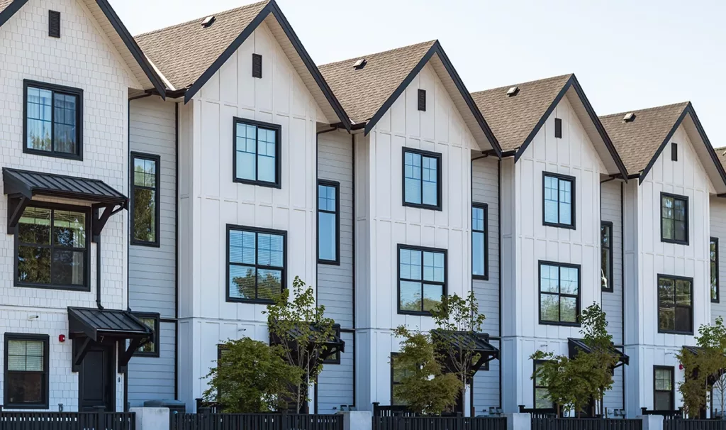 The exterior of a newly renovated apartment complex, with white paint and black trim