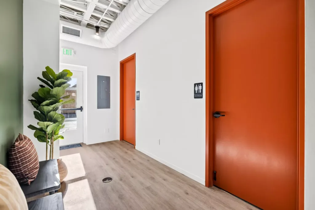 Hallway in front of restrooms with seating area