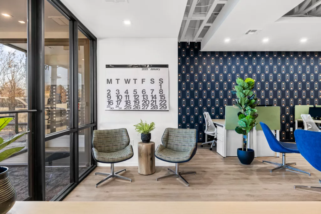 Seating area with chairs and planters in a bright, well lit office space