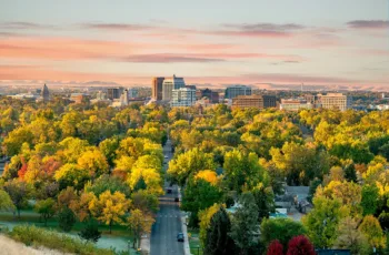 Bird's eye view of Boise, Idaho at sunset, with vibrant green trees and colorful houses, showing the concept of the best places in Idaho to build a new home