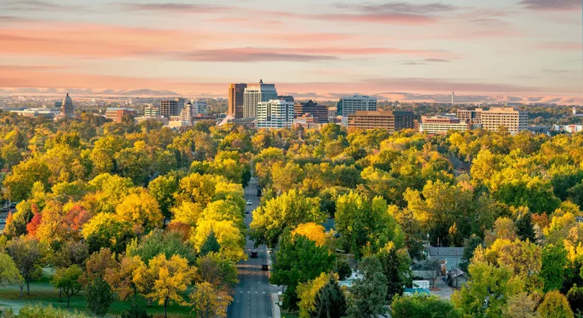 Bird's eye view of Boise, Idaho at sunset, with vibrant green trees and colorful houses, showing the concept of the best places in Idaho to build a new home