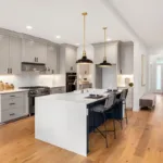 The interior of a bright, newly updated kitchen with hardwood floors, showing the concept of the best home renovations to increase value