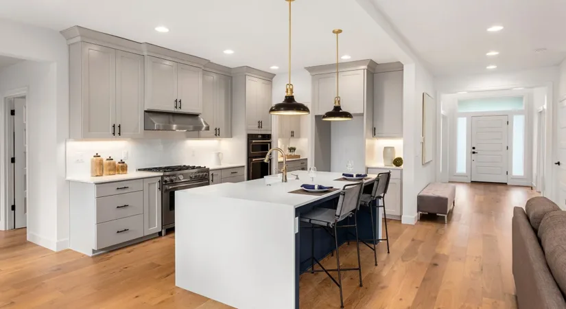 The interior of a bright, newly updated kitchen with hardwood floors, showing the concept of the best home renovations to increase value