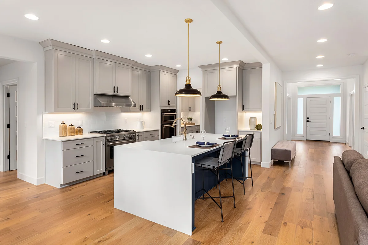 The interior of a bright, newly updated kitchen with hardwood floors, showing the concept of the best home renovations to increase value